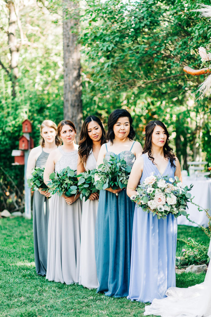 The Gold Mountain Manor In Big Bear, CA wedding photography; bridesmaids standing while holding bouqet
