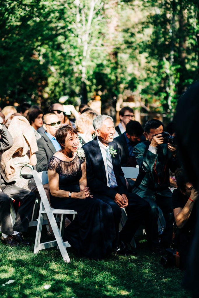 The Gold Mountain Manor In Big Bear, CA wedding photography; guests sitting and looking at the couple