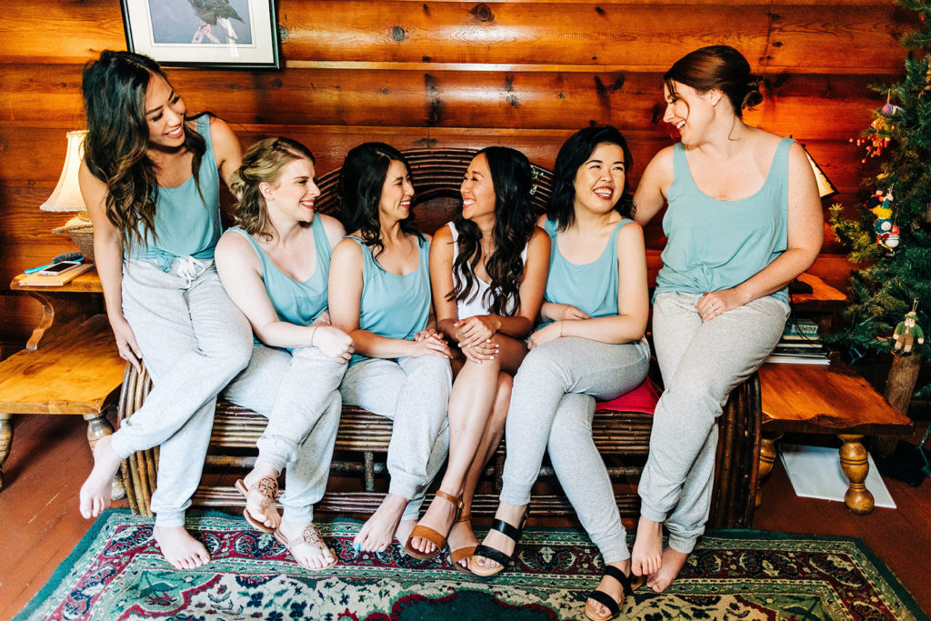 The Gold Mountain Manor In Big Bear, CA wedding photography; bridesmaids laughing in a rustic room