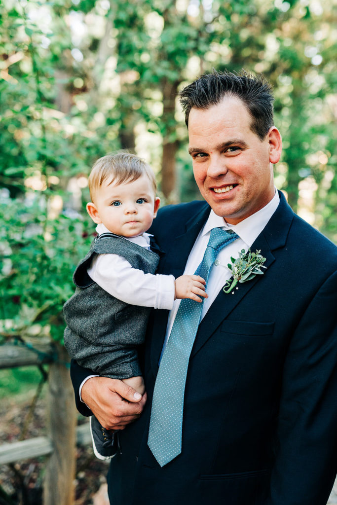 The Gold Mountain Manor In Big Bear, CA wedding photography; a man with his cute child at wedding