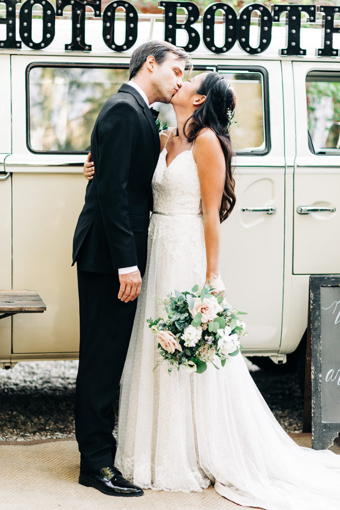 The Gold Mountain Manor In Big Bear, CA wedding photography; bride and groom kissing in front of photo booth van