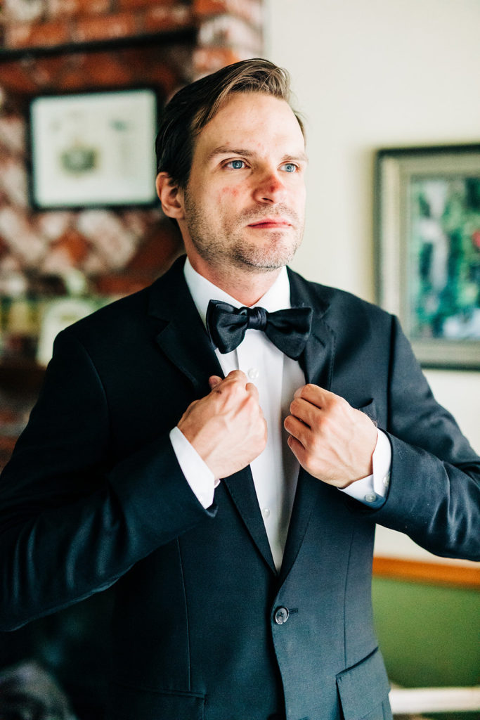 The Gold Mountain Manor In Big Bear, CA wedding photography; groom adjusting his blazer