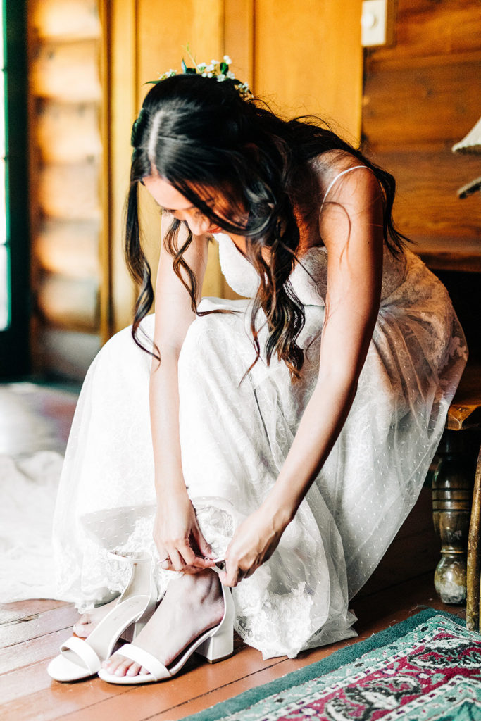 The Gold Mountain Manor In Big Bear, CA wedding photography; bride putting on shoes