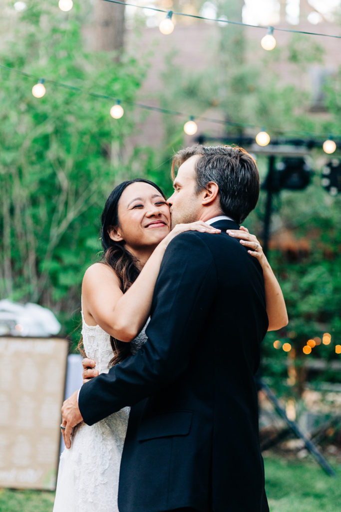 The Gold Mountain Manor In Big Bear, CA wedding photography; groom kissing his bride on cheeks