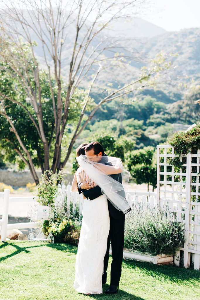 Sweet Pea Ranch In Upland, CA wedding photography; bride and groom hugging each other