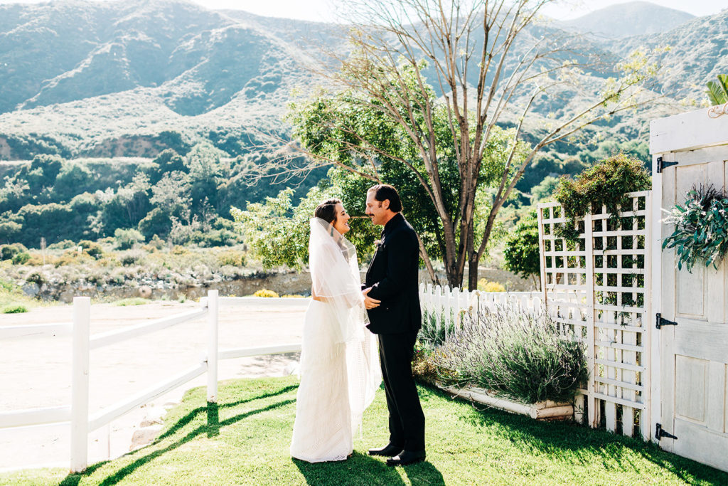 Sweet Pea Ranch In Upland, CA wedding photography; bride and groom looking at each other's eyes while holding hands