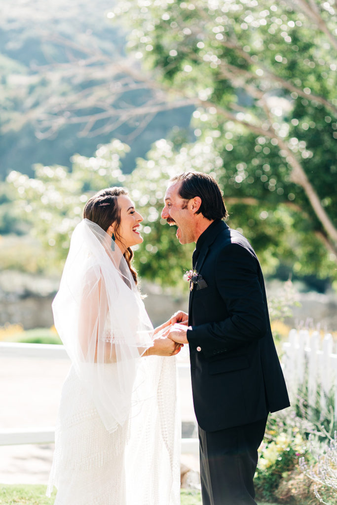 Sweet Pea Ranch In Upland, CA wedding photography; bride and groom laughing together