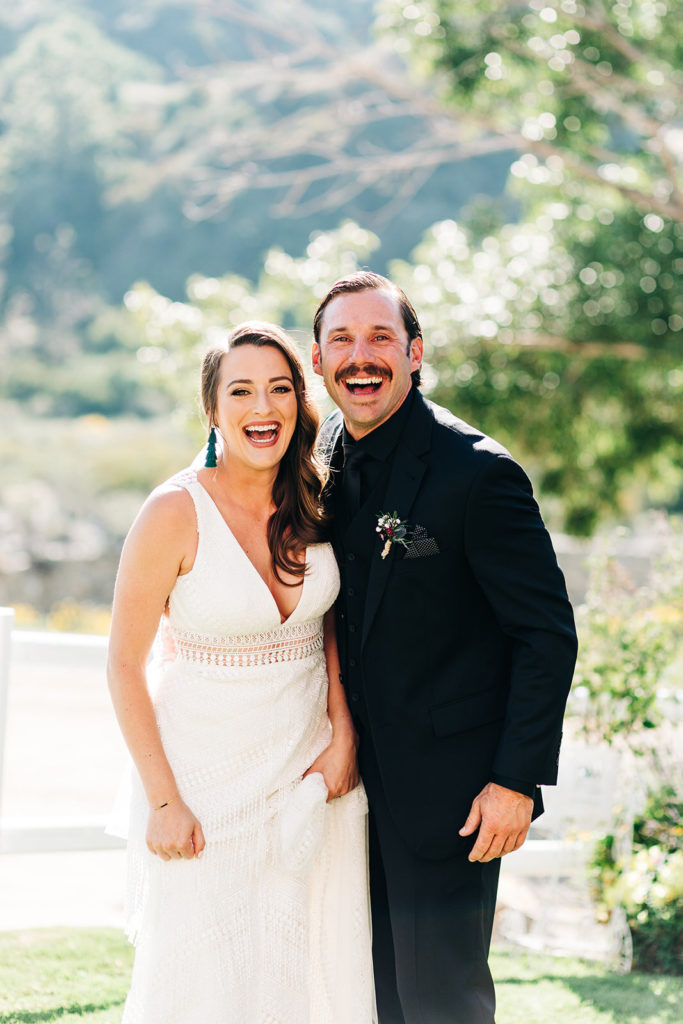 Sweet Pea Ranch In Upland, CA wedding photography; bride and groom laughing together
