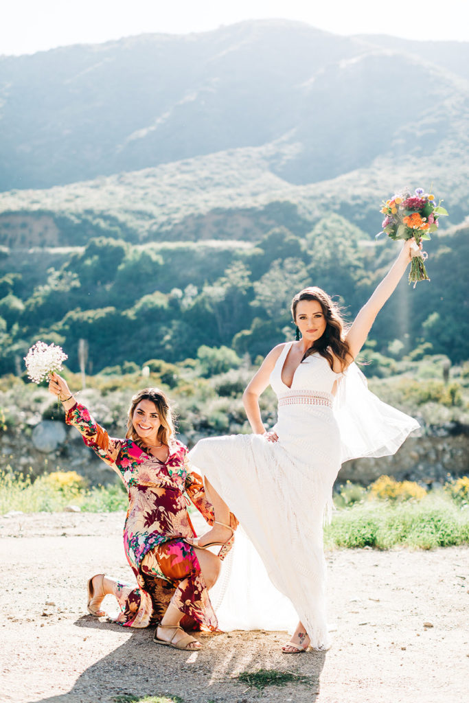 Sweet Pea Ranch In Upland, CA wedding photography; lovely photo of bride with bridesmaid in front of beautiful mountain