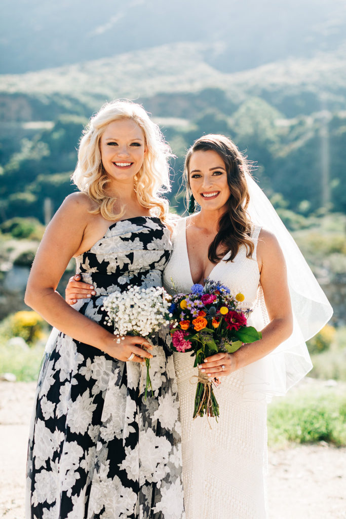 Sweet Pea Ranch In Upland, CA wedding photography; bride with bridesmaid in front of beautiful mountain