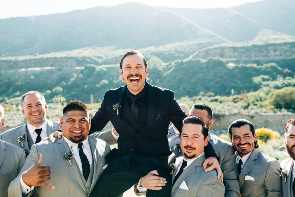 Sweet Pea Ranch In Upland, CA wedding photography; groom beig lifted up by groomsmen
