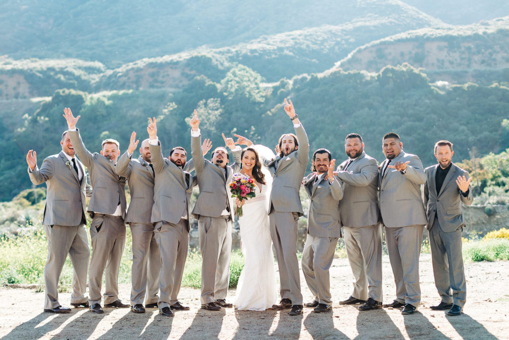 Sweet Pea Ranch In Upland, CA wedding photography; bride with groomsmen in front of beautiful mountain