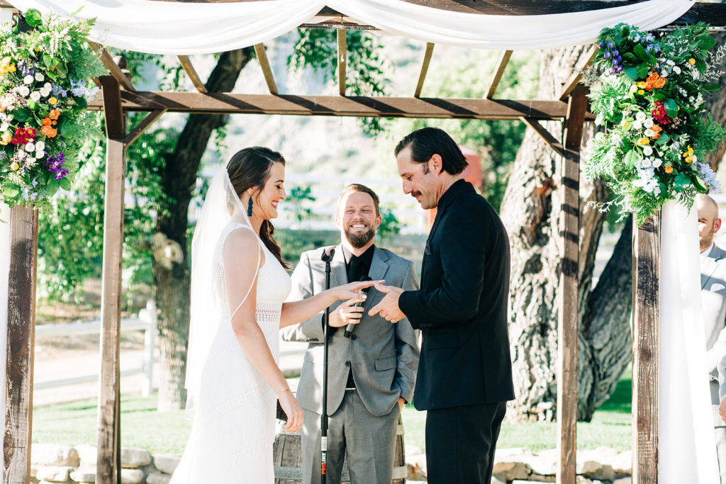 Sweet Pea Ranch In Upland, CA wedding photography; groom placing the ring in ring finger