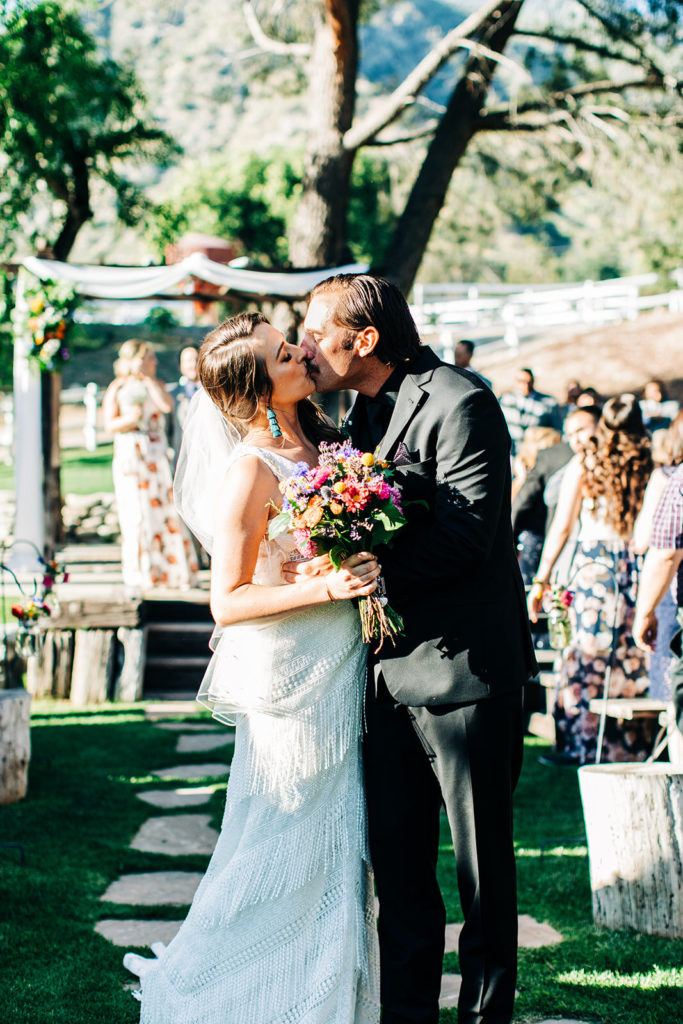 Sweet Pea Ranch In Upland, CA wedding photography; bride and groom kissing on the aisle