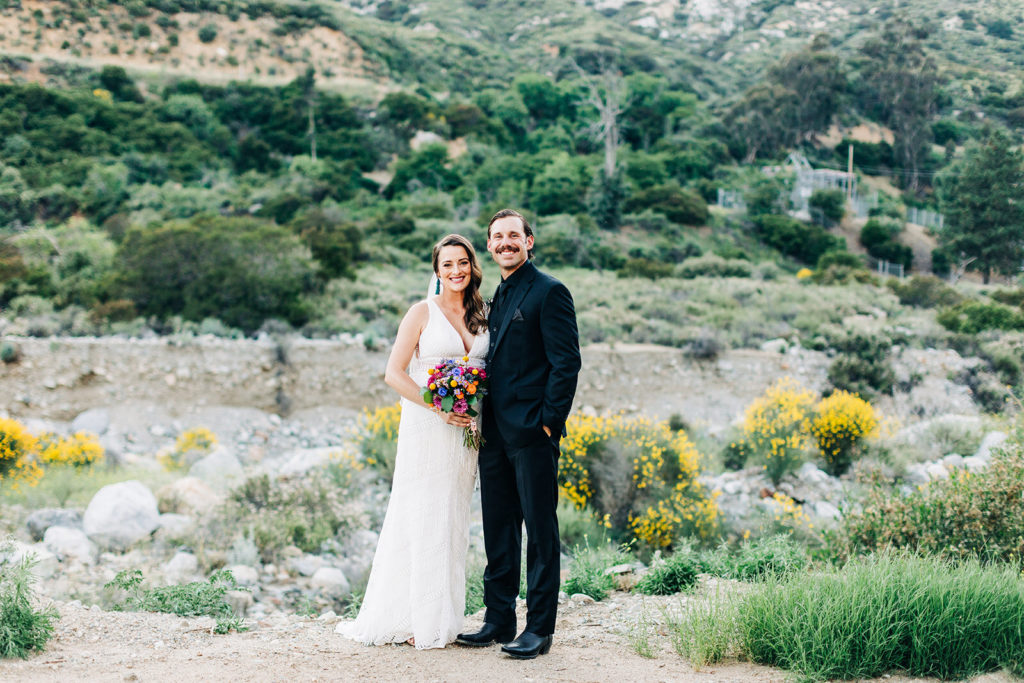 Sweet Pea Ranch In Upland, CA wedding photography; bride and groom standing on the hill