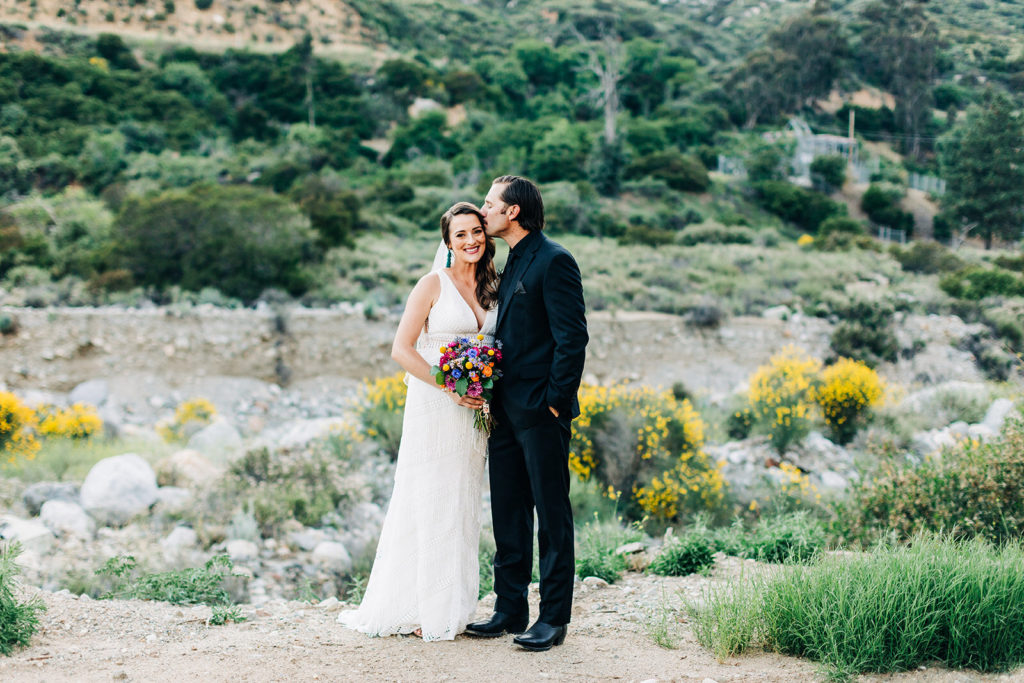 Sweet Pea Ranch In Upland, CA wedding photography; groom kissing his bride