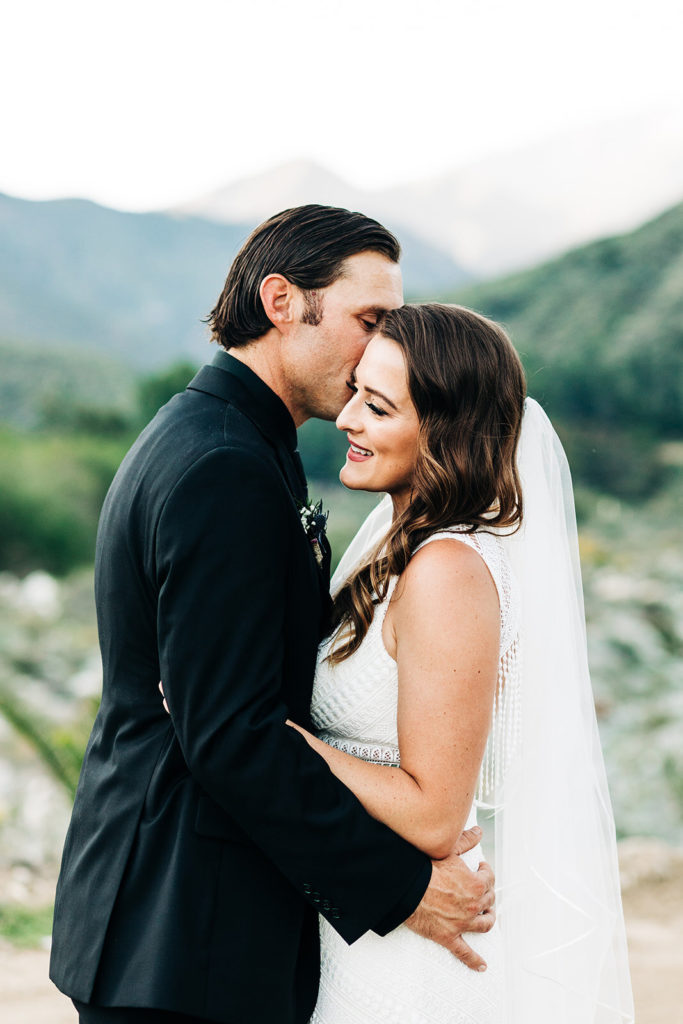 Sweet Pea Ranch In Upland, CA wedding photography; groom kissing his bride