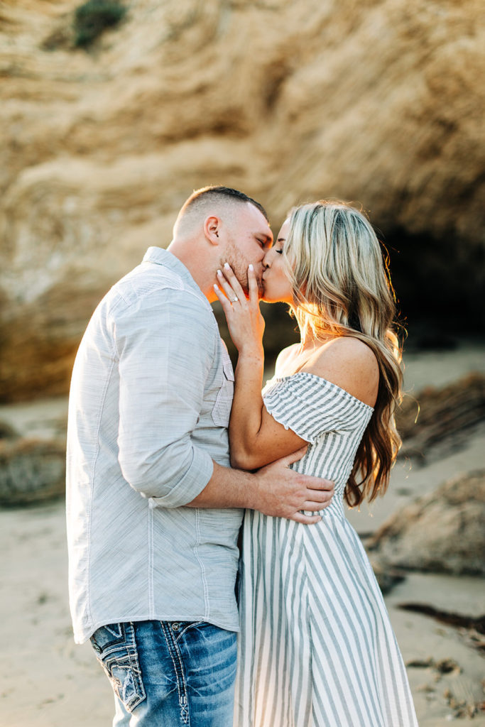 crystal cove beach engagement photos in orange county; couple kissing at the beach