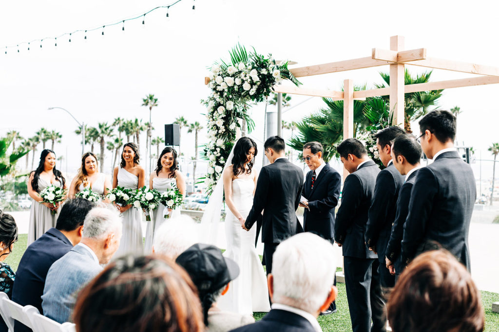 Pasea Hotel & Spa in Huntington Beach, CA wedding photography; bride and grooms holding each other's hands