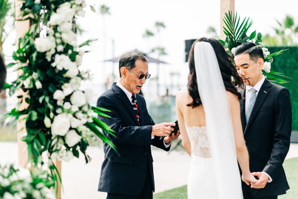 Pasea Hotel & Spa in Huntington Beach, CA wedding photography; bride and groom holding hands