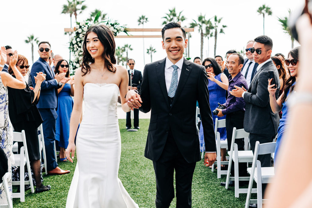 Pasea Hotel & Spa in Huntington Beach, CA wedding photography; bride and groom walking through the aisle