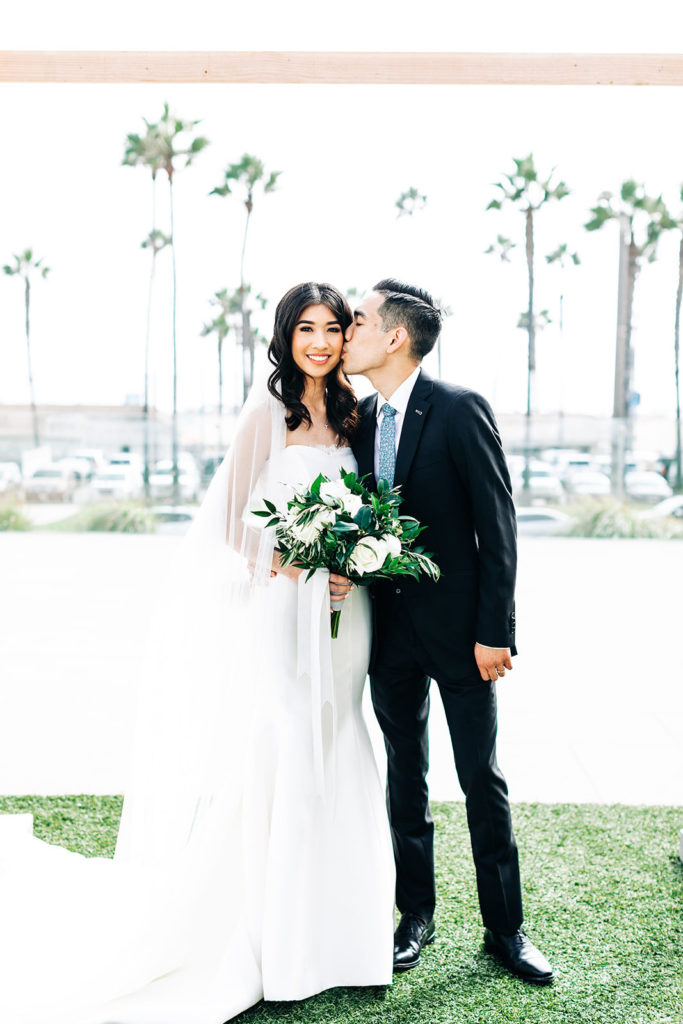 Pasea Hotel & Spa in Huntington Beach, CA wedding photography; groom kissing his bride