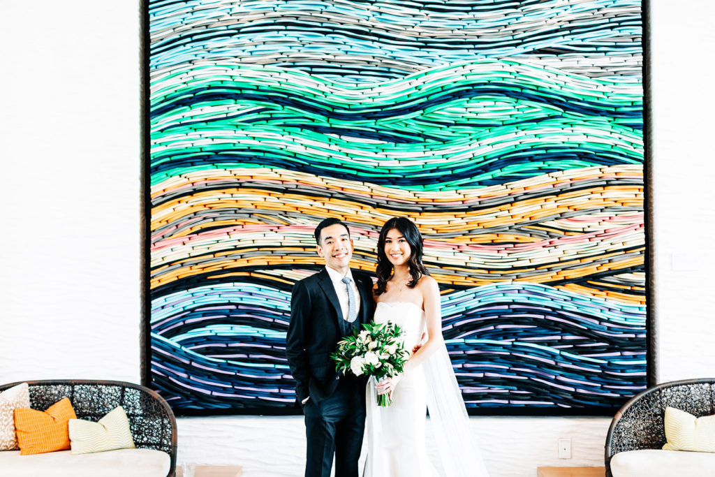 Pasea Hotel & Spa in Huntington Beach, CA wedding photography; bride and groom's in front of a beautiful wall painting