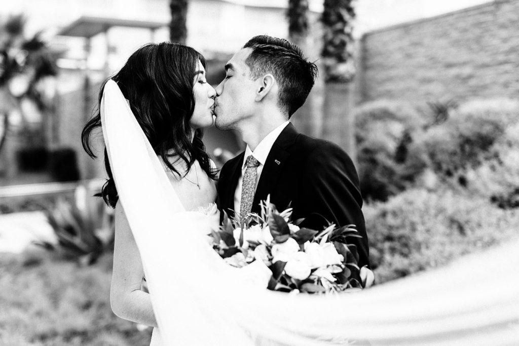 Pasea Hotel & Spa in Huntington Beach, CA wedding photography; black and whit photo of bride and groom while kissing each other