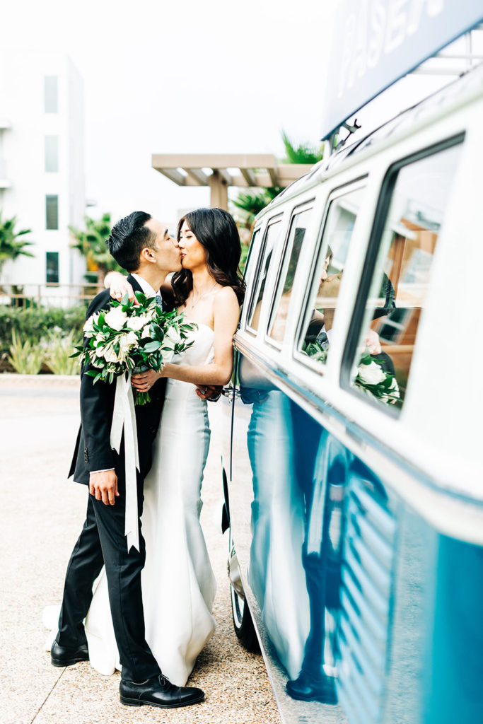 Pasea Hotel & Spa in Huntington Beach, CA wedding photography; bride and groom kissing each other by the side of VW