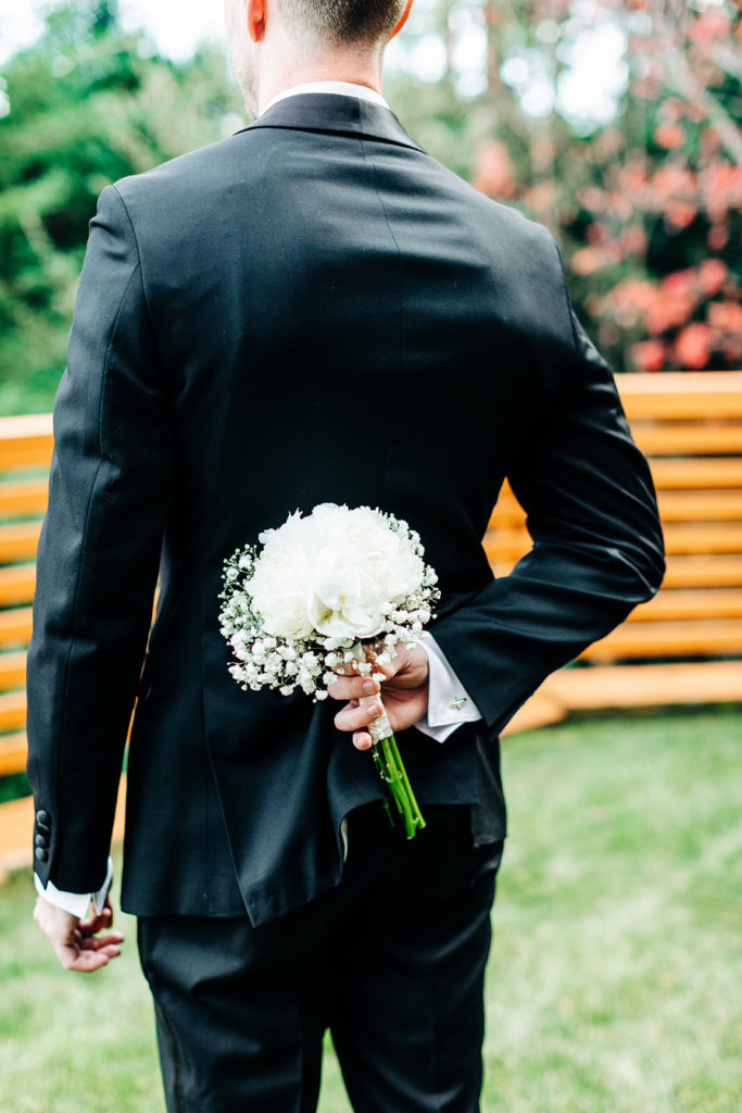 City Hall in San Francisco, CA wedding photography; groom holding beautiful flowers