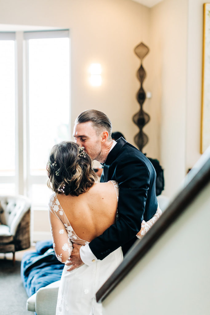 City Hall in San Francisco, CA wedding photography; groom hugging and kissing his bride