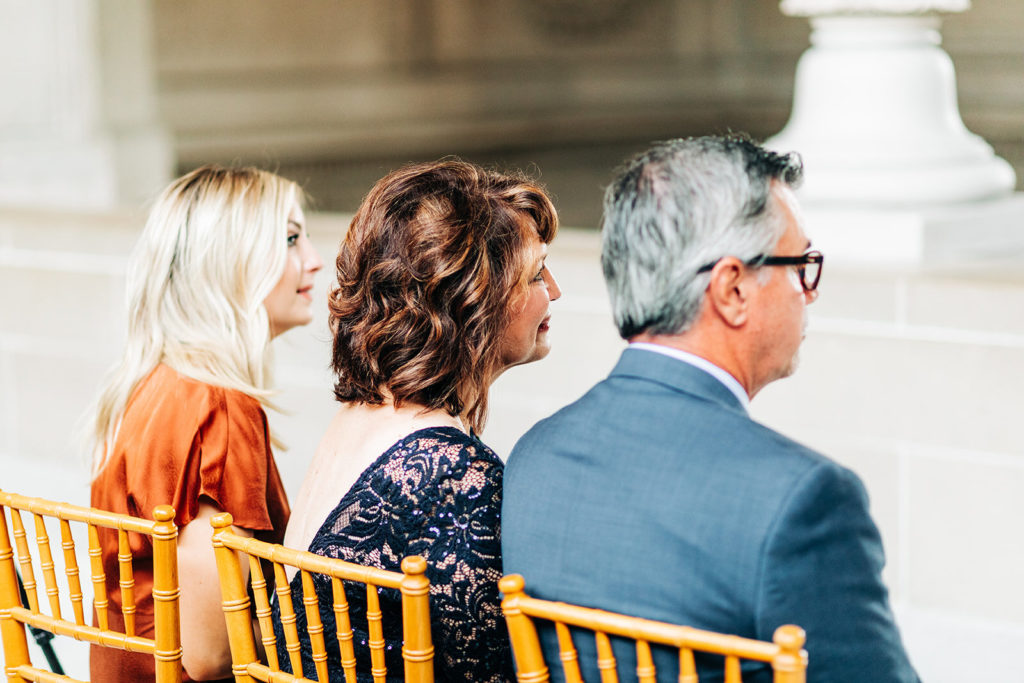 City Hall in San Francisco, CA wedding photography; guests sitting