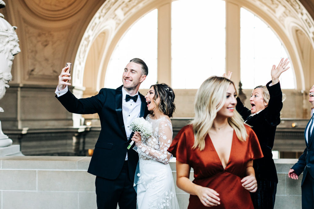 City Hall in San Francisco, CA wedding photography; bride and groom taking selfie
