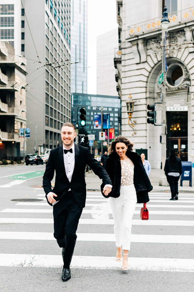 City Hall in San Francisco, CA wedding photography; bride and groom crossing the road
