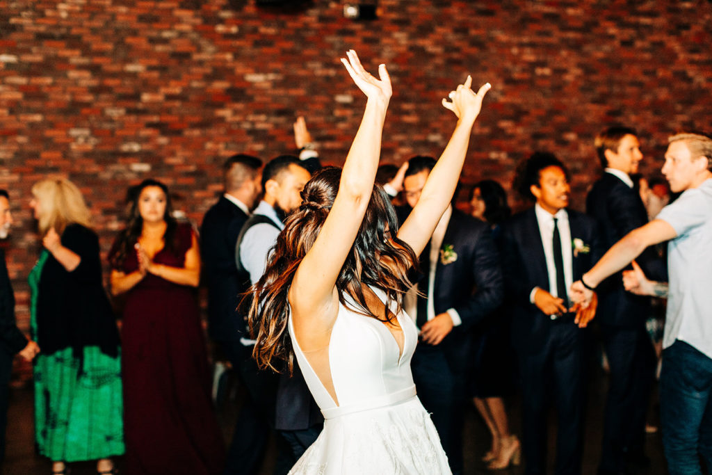 Colony house in Anaheim, CA wedding photography; bride dancing and enjoying