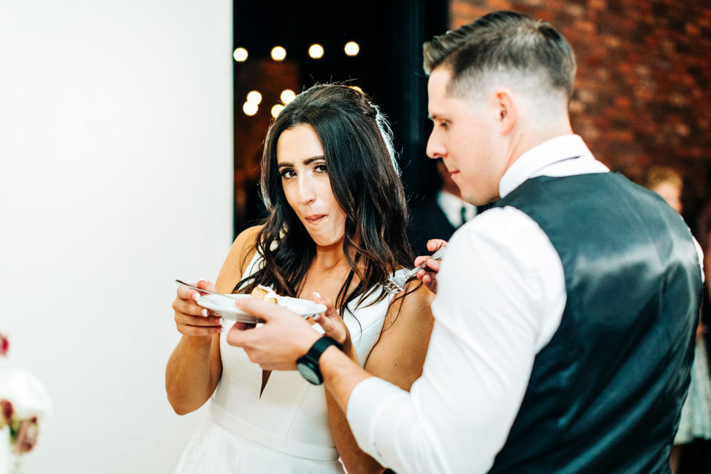 Colony house in Anaheim, CA wedding photography; bride and groom eating the piece of wedding cake