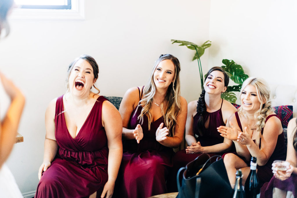 Colony house in Anaheim, CA wedding photography; bridesmaids looking at bride