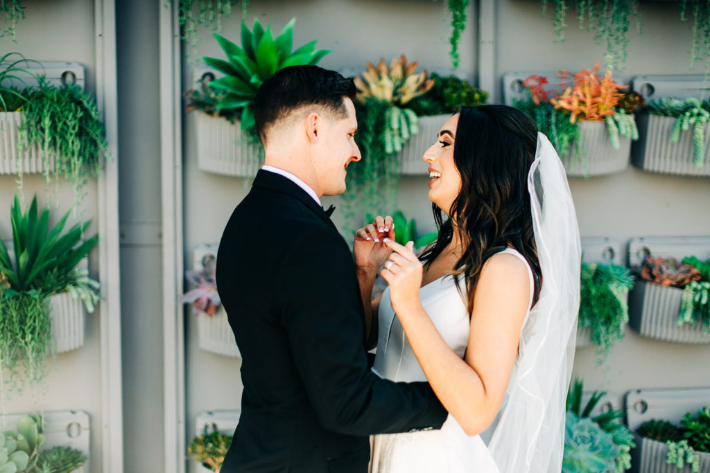 Colony house in Anaheim, CA wedding photography; bride and groom about to hug each other