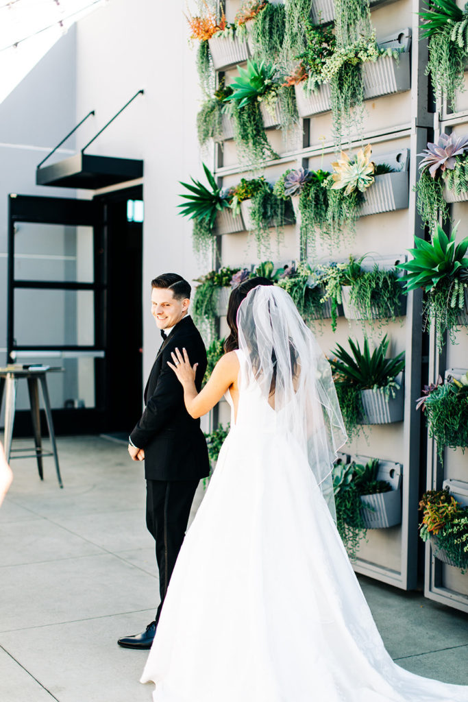 Colony house in Anaheim, CA wedding photography; bride approaching the groom for a first look