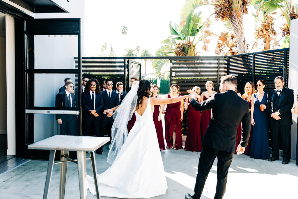 Colony house in Anaheim, CA wedding photography; bride and groom dancing and guests watching them