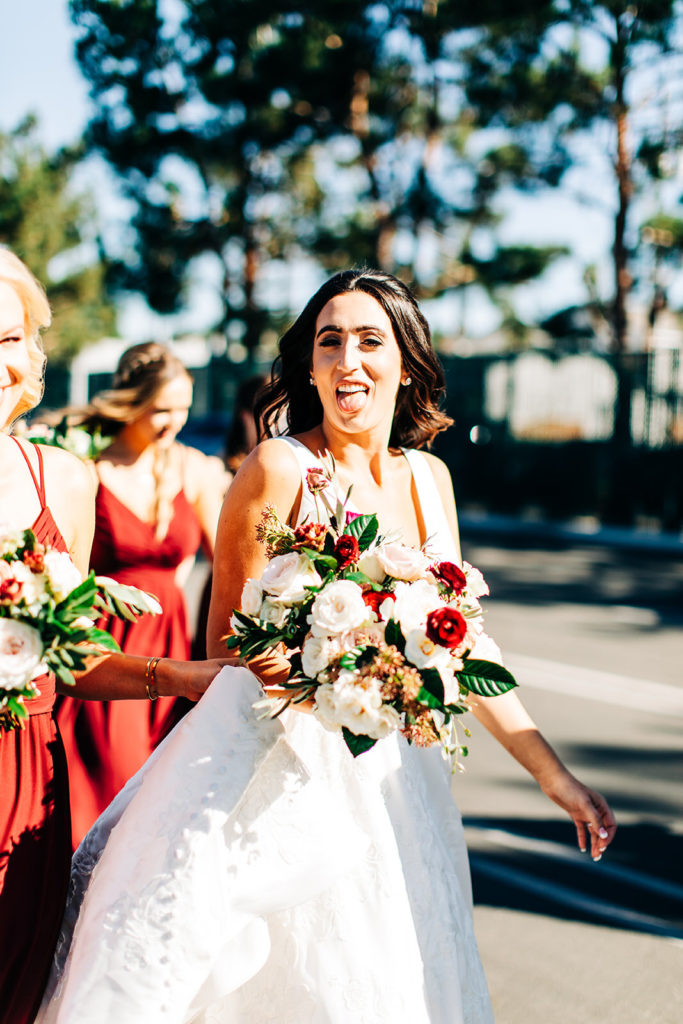 Colony house in Anaheim, CA wedding photography; happy bride with beautiful flowers in her hands