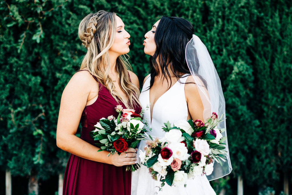 Colony house in Anaheim, CA wedding photography; bride greeting with her friend