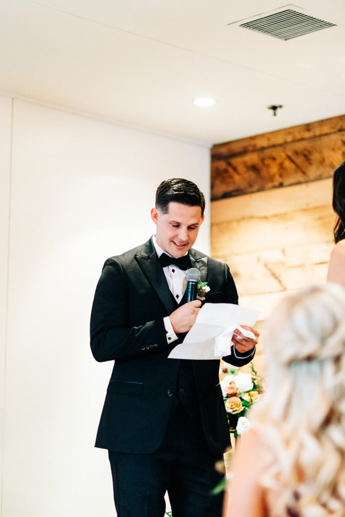 Colony house in Anaheim, CA wedding photography; groom reading his vows