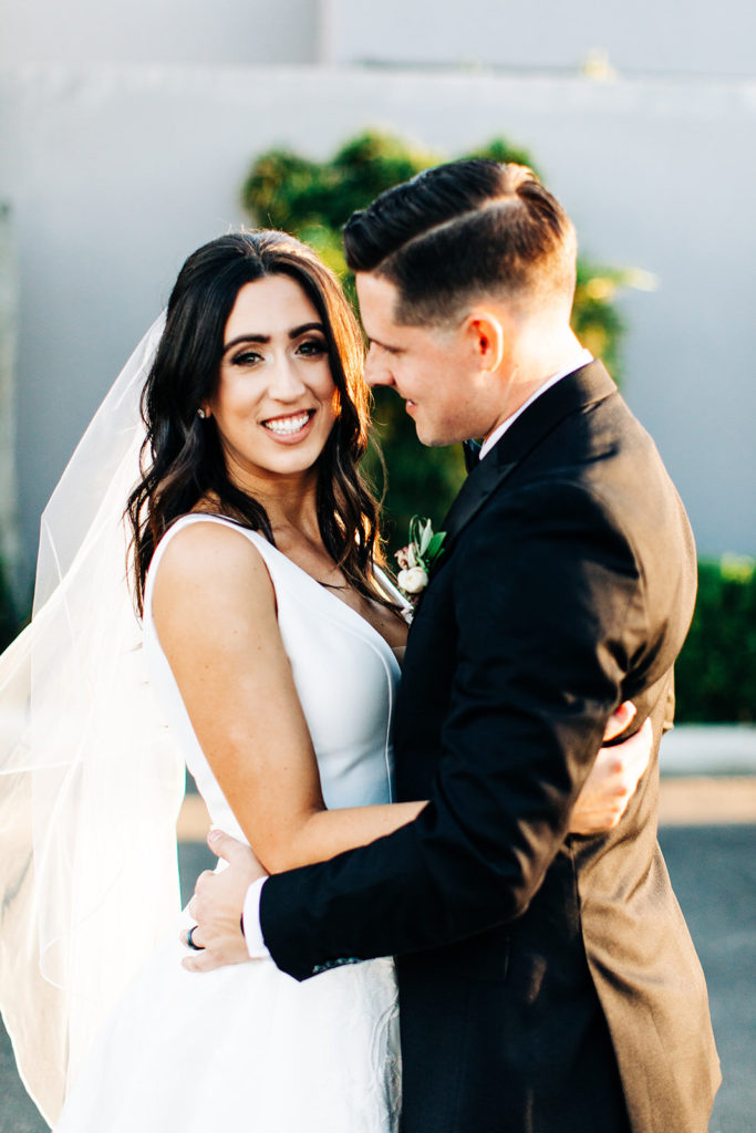 Colony house in Anaheim, CA wedding photography; bride and groom hugging