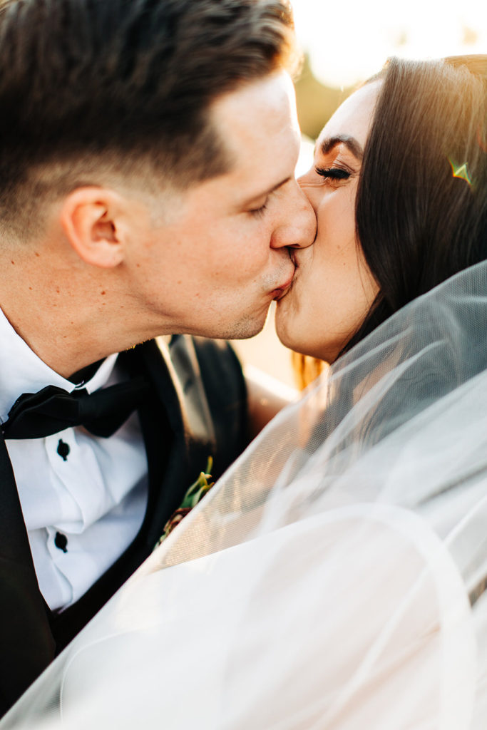 Colony house in Anaheim, CA wedding photography; bride and groom kissing