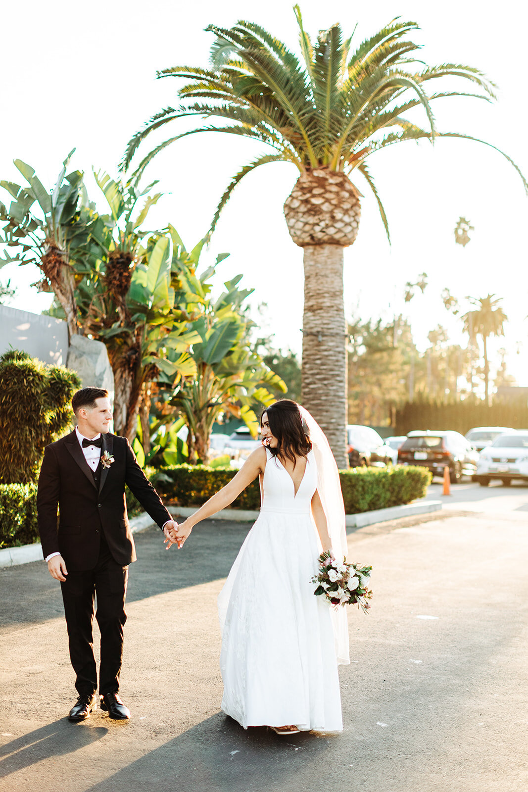 Colony house in Anaheim, CA wedding photography; groom taking his bride with him