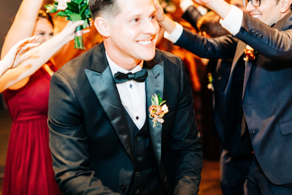 Colony house in Anaheim, CA wedding photography; groom smiling and enjoying