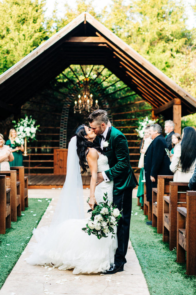 Avalon Legacy Ranch wedding photography; bride & groom kissing in the aisle