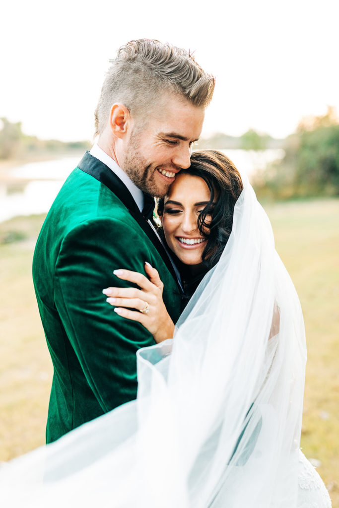 Avalon Legacy Ranch wedding photography; bride and groom hugging & smiling