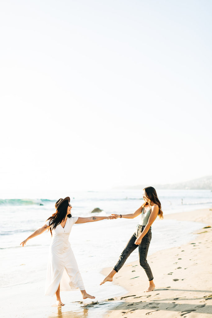lesbian couple dancing on the beach in laguna beach, ca